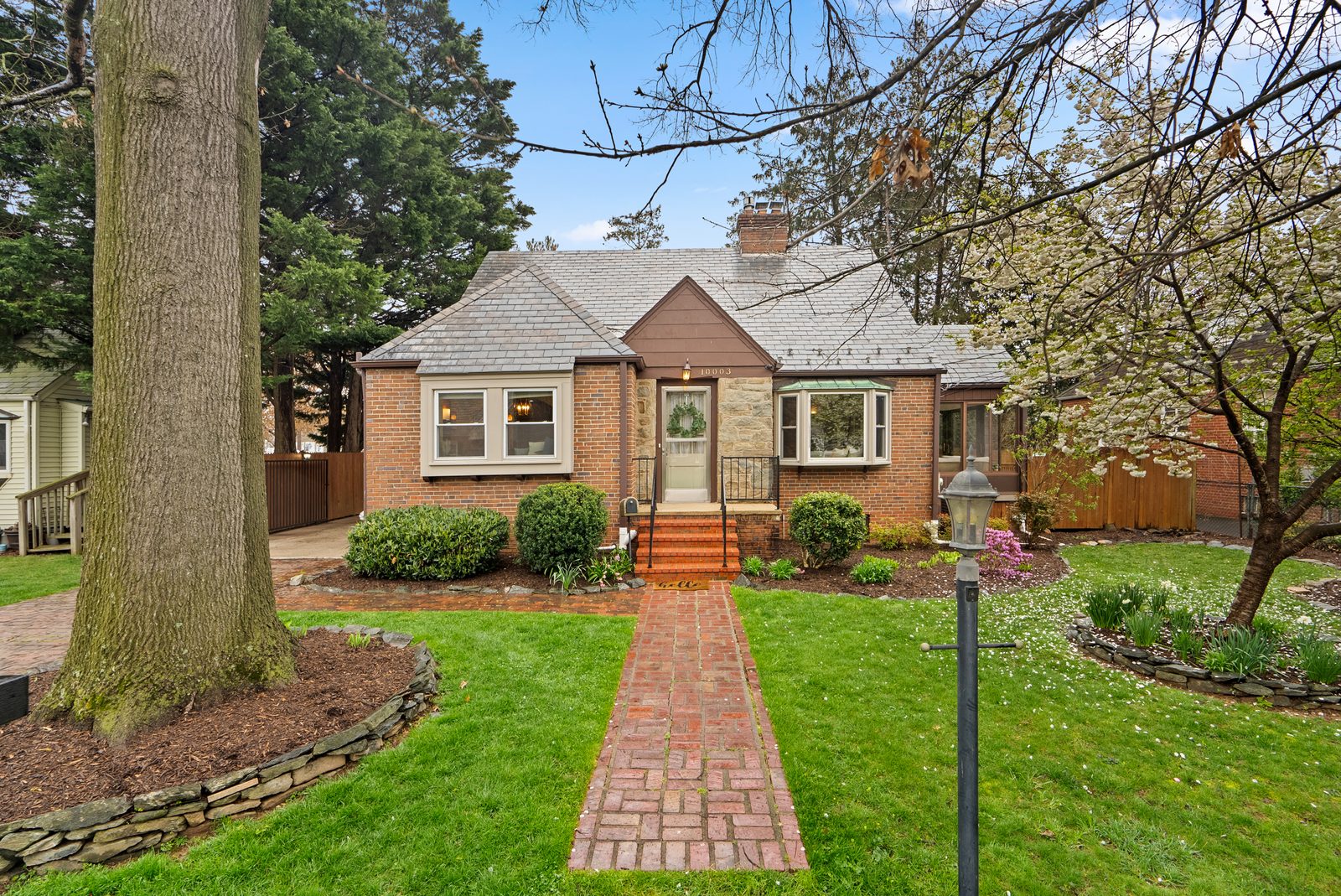 Brick cape with slate roof and brick walkway